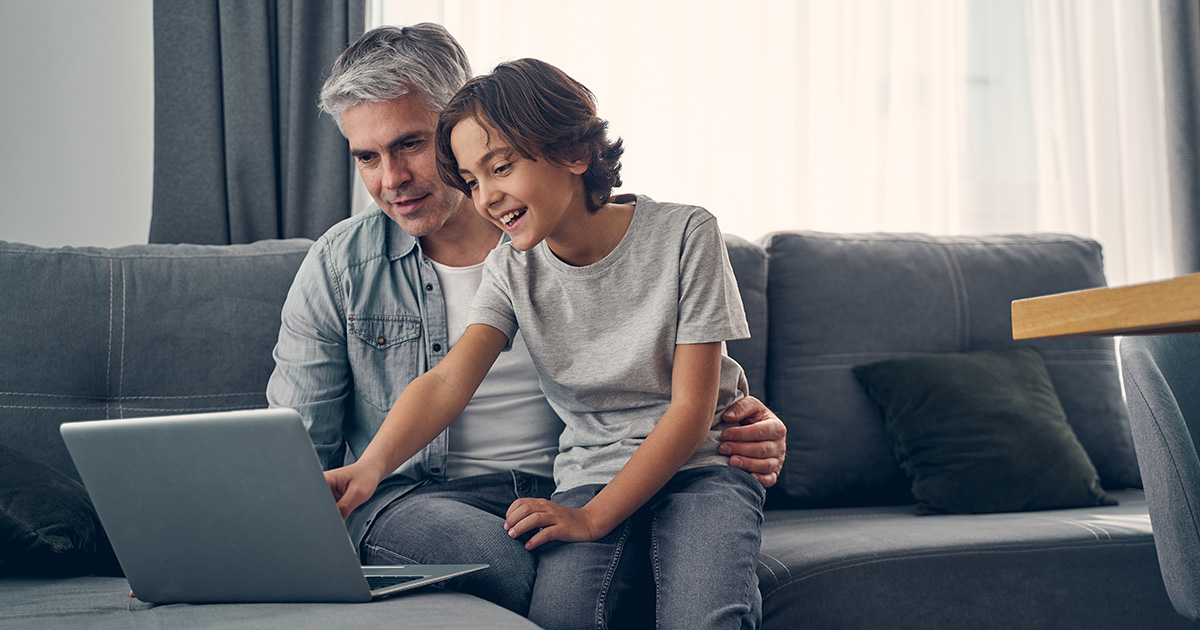 Photo of father and son reviewing energy prices.