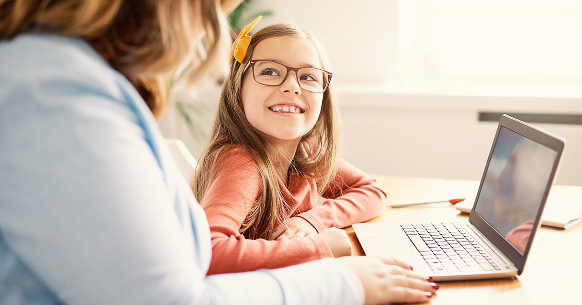 Photo of mother and daughter using energy tools online