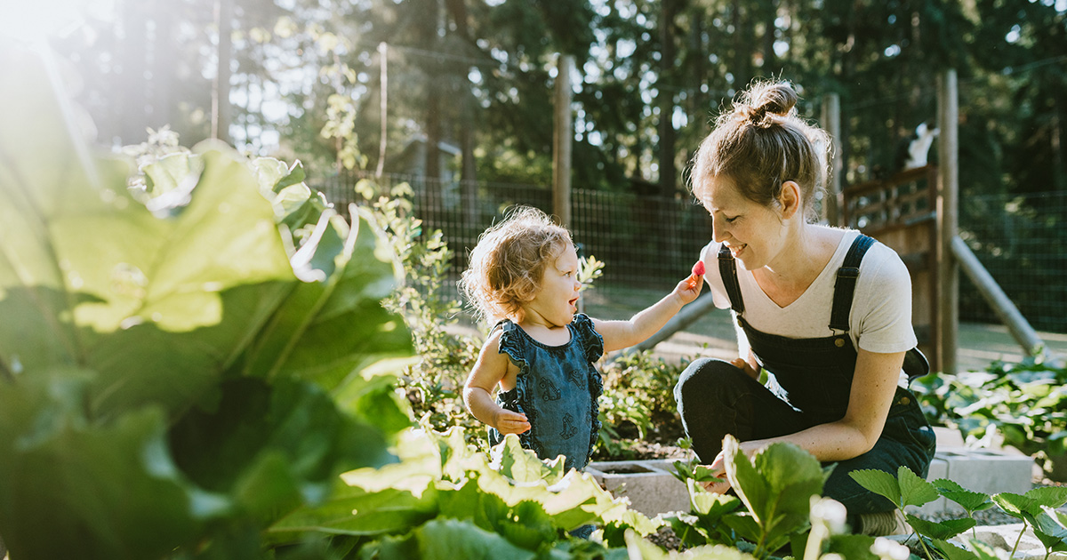 Photo of mother and daughter working in the garden